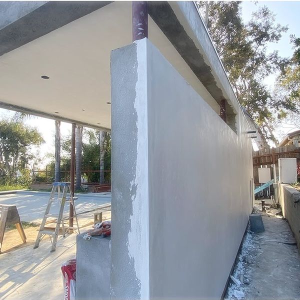 Photo: pool house wall with a fresh stucco finish