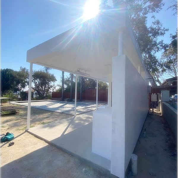 Photo: freshly stuccoed pool house in the afternoon sun