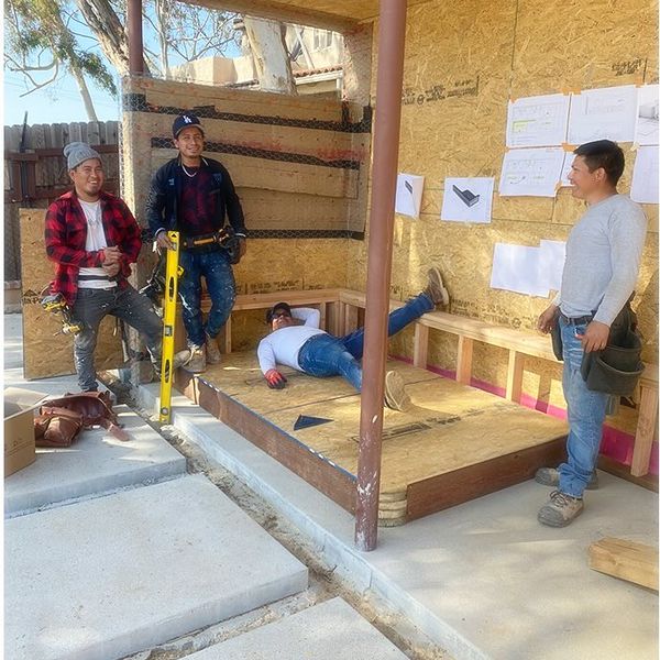 Photo: ROAM crew meeting on site inside the framing